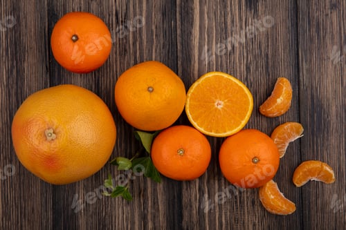 Preview: top view oranges with peeled wedges and grapefruit on wooden background