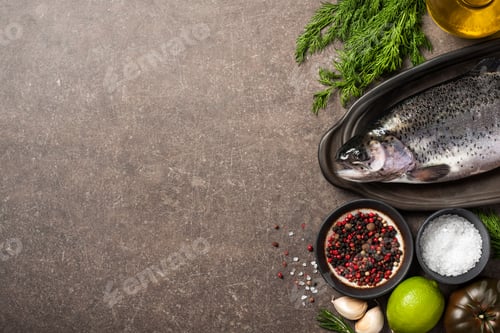Preview: Fresh trout fish and ingredients on kitchen table