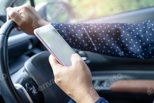 Preview: Holding mobile phone in car to communication with family and friends.