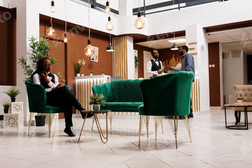 Preview: Hotel manager talking phone in lobby