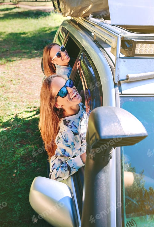 Preview: Happy women having fun through the window car