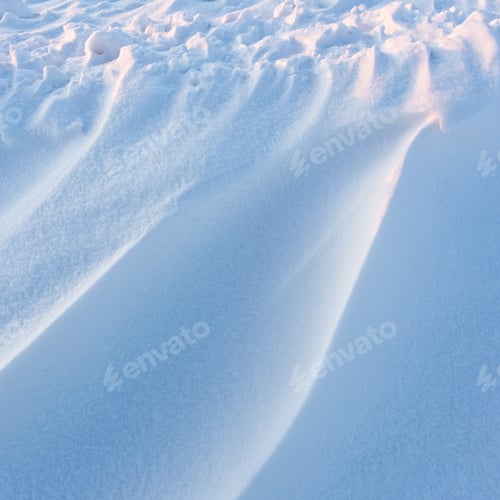 Preview: Snowdrift waves in sunset light, winter background of snow waves