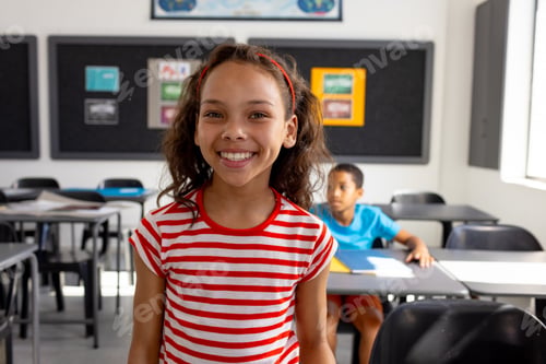 Preview: In school, in the classroom, a biracial girl and boy are focusing on learning