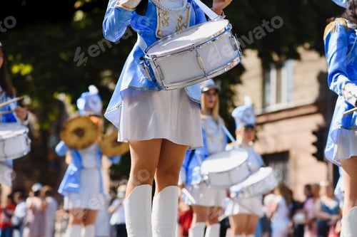 Preview: majorettes with white and blue uniforms perform in the streets of the city. photographic series