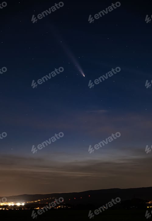Preview: Comet over a starry night cityscape