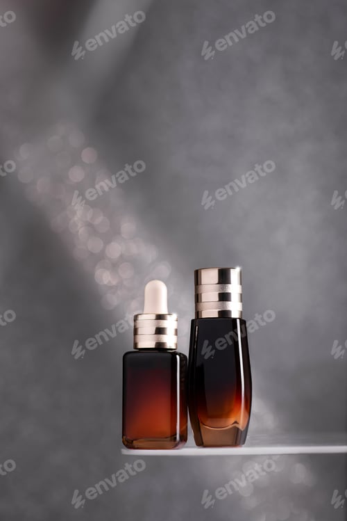 Preview: Serum bottles on reflective surface with shadow