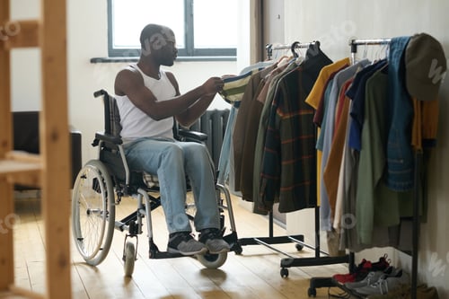 Preview: Disabled man choosing clothes to wear