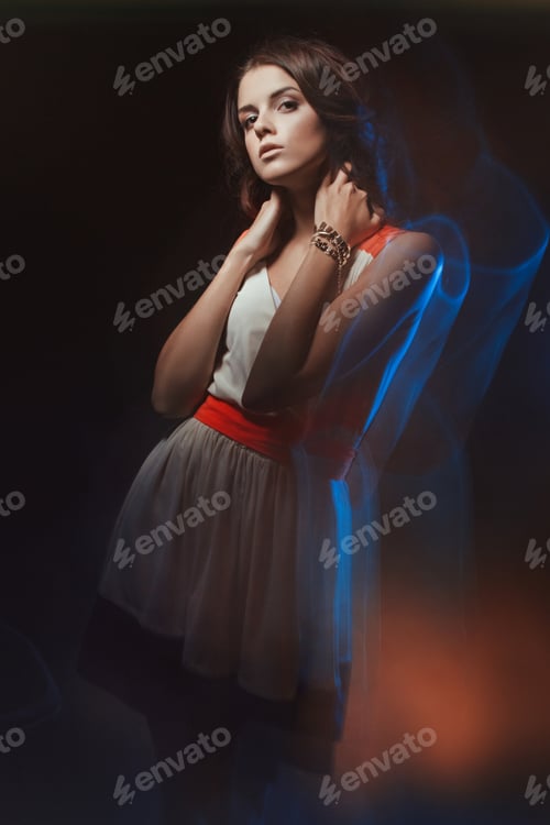 Preview: Blurred color art portrait of a girl on a dark background. Fashion woman with beautiful makeup and a