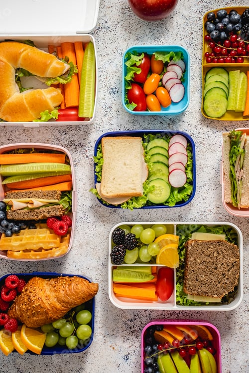 Preview: Shot of school lunchboxes with various healthy nutritious meals on stone background