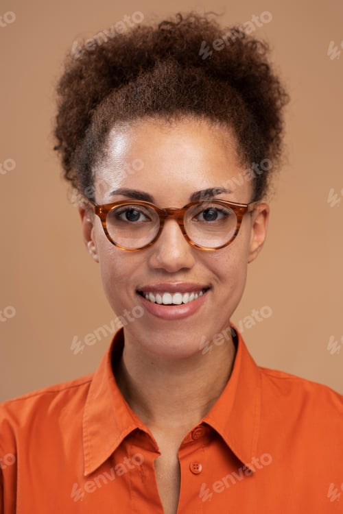 Preview: Vertical portrait of smiling African American woman in glasses smiling to camera