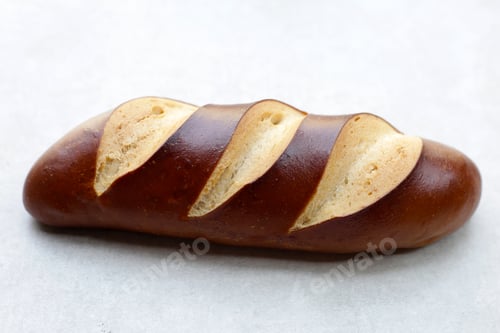 Preview: Plain Laugen bread on grey background.