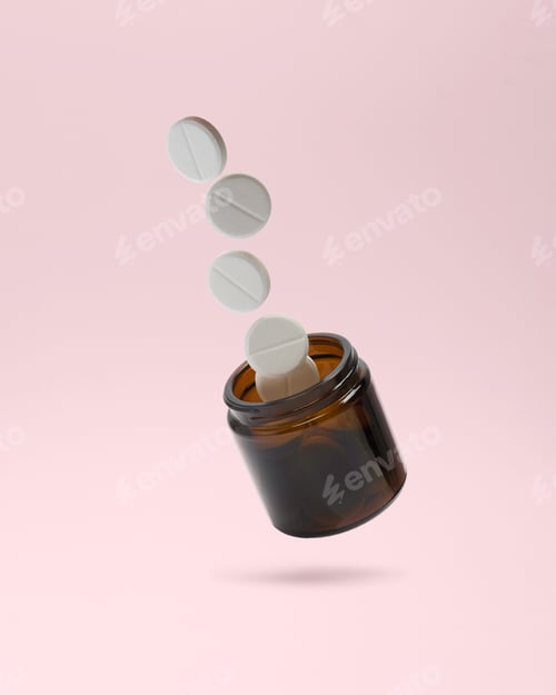 Preview: White tablets levitate above an amber bottle on a soft pink background