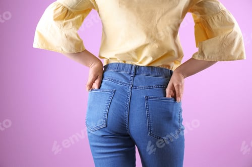 Preview: Woman in stylish blue jeans on color background