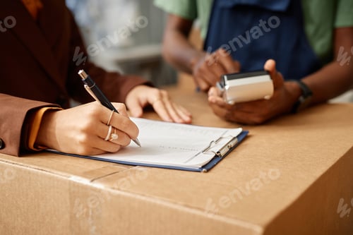 Preview: Woman signing a contract with moving service
