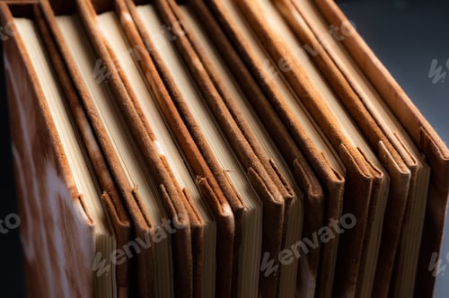 Preview: Pile of handmade notebooks isolated against black background