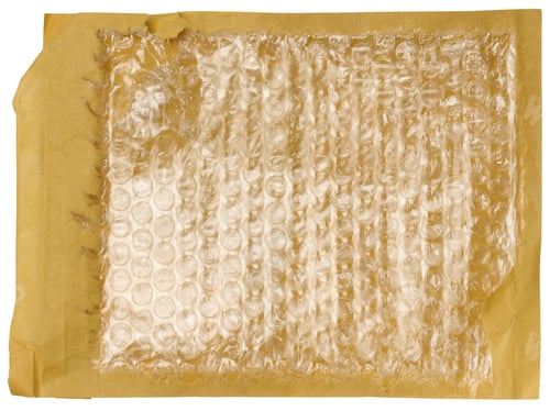 Preview: A fragment of an envelope made of brown paper with bubble wrap inside.