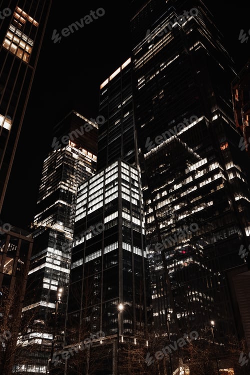 Preview: Urban cityscape at night with illuminated skyscrapers against the dark night sky