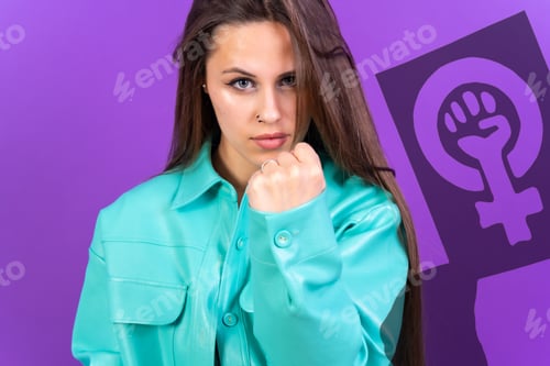 Preview: Angry young woman showing a fist- feminism, women's day, on a purple background