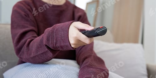 Preview: Cozy Home Lifestyle Person Relaxing on Couch with Remote Control, Casual Clothing, Comfortable