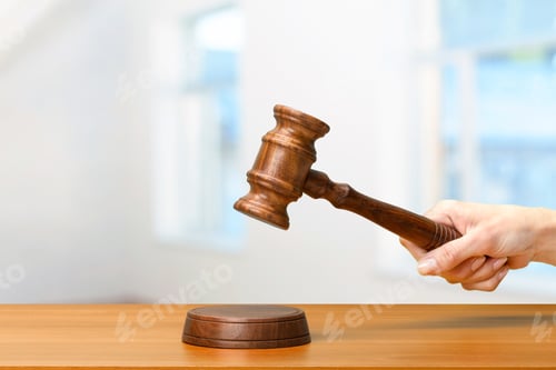 Preview: someones hand holding Wooden Law Gavel