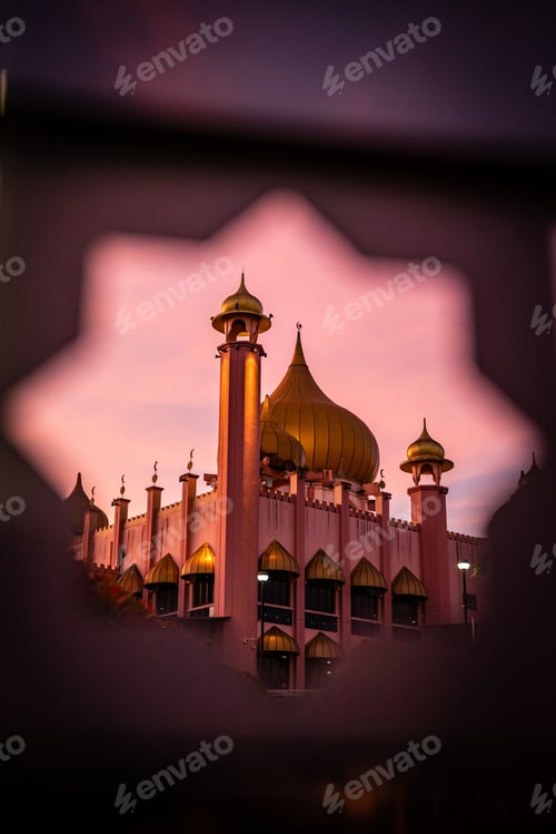 Preview: Vertical shot of the Kuching City Mosque in Malaysia at sunset framed by a star on the gate