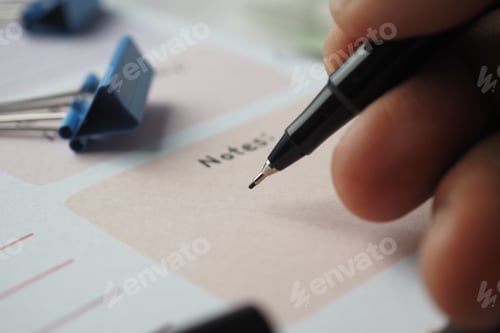 Preview: man hand writing on notepad while sited
