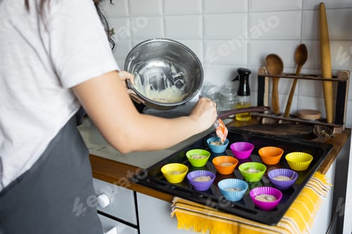 Preview: making of delicious cupcake in kitchen. Muffin tin with liner, ingredients, and utensils are seen. A