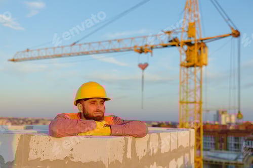 Preview: Construction Worker Resting by Crane at Sunset