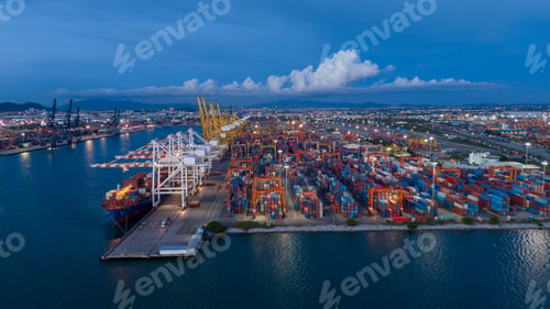 Preview: crane loading cargo container from truck to container ship in the international t