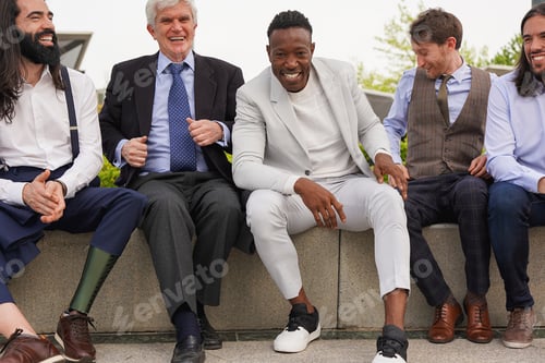 Preview: Group of multiracial business men having fun together during lunch break outside of office