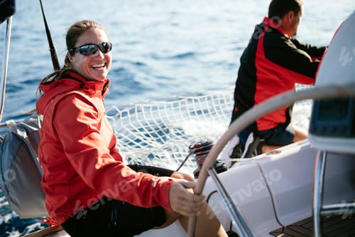 Preview: Attractive strong woman sailing with her boat