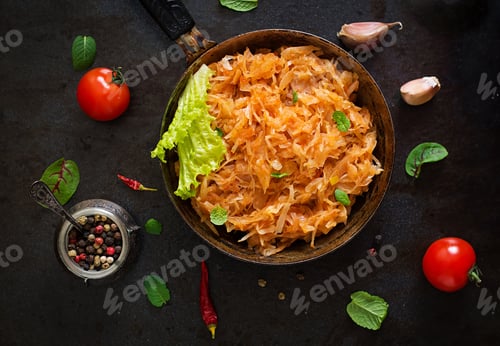 Preview: Stewed cabbage on the old wooden background in rustic style. Top view