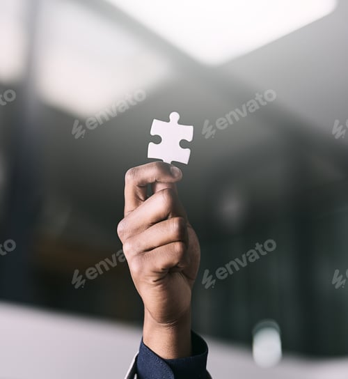 Preview: Closeup shot of an unrecognizable businessman holding a puzzle piece in an office