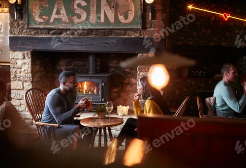 Preview: Couple Meeting For Lunchtime Drinks In Traditional English Pub Making A Toast