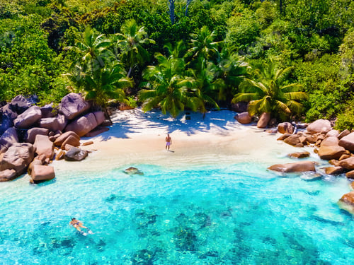 Preview: Praslin Seychelles tropical island with withe beaches and palm trees, couple men and women mid age