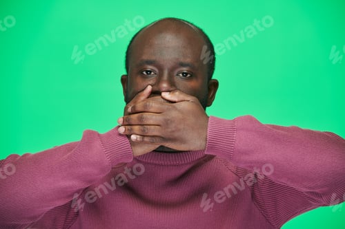 Preview: African American man closing his mouth with hands
