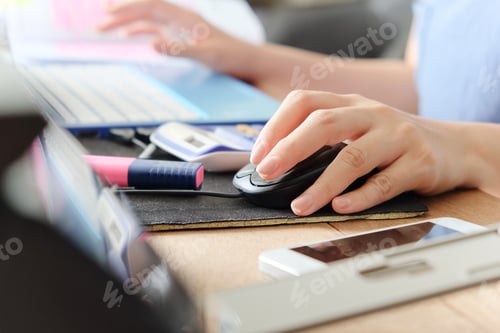 Preview: Macro shot of a woman hand using a computer mouse.