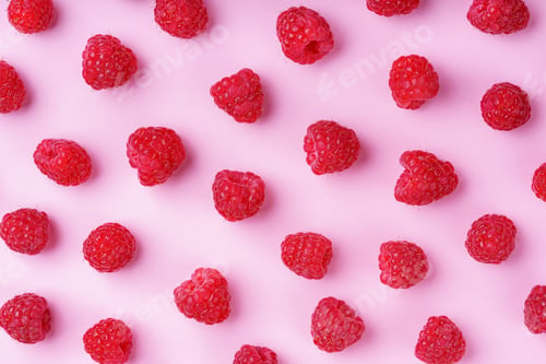 Preview: Fresh Ripe Red Raspberries Scattered On Pink Background In Vibrant Minimalistic Food Composition