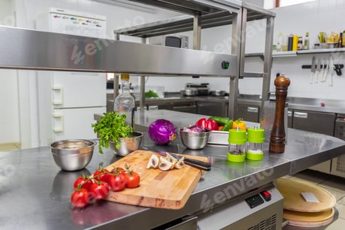 Preview: Cutting vegetables and preparing meals in a modern restaurant kitchen setting