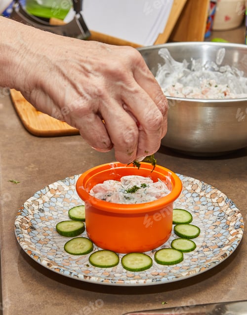 Preview: Chef preparing gourmet tartare with salmon and cheese on a plate