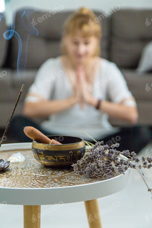 Preview: Woman doing yoga at home and aromatherapy. Selective focus.