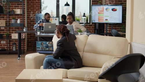 Preview: Young employee attending business meeting on videocall