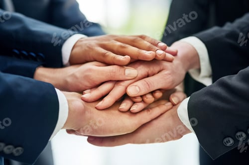 Preview: Closeup shot of a group of businesspeople standing in a huddle with their hands stacked together
