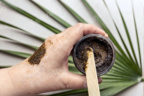Preview: In a woman's hand is a jar with a Body Scrub made from natural ingredients. Handmade cosmetics.