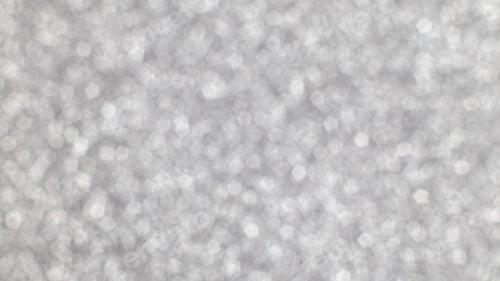 Preview: Silver festive Christmas background. Abstract shimmering background with bokeh silver lights
