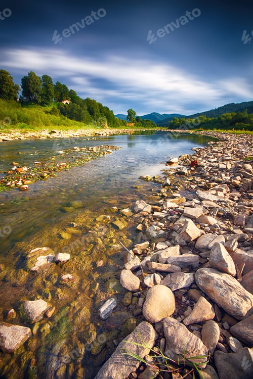 Preview: moutaine River with crystal clear water and dramatic sky.