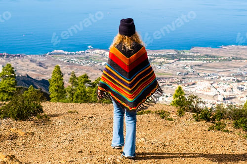 Preview: Back view of tourist and traveler walking to the cliff to admire the amazing coastline view.