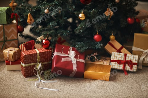 Preview: Christmas Gifts Arranged under Tree Awaiting Celebration and Family Gathering