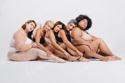 Preview: group of multi ethnic women in underwear, sitting in profile in row lying quietly between themselves