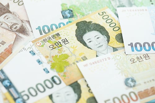 Preview: South Korean won money bills in big amount lies on white color table close up